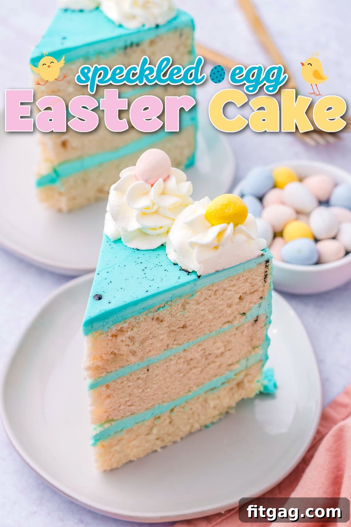 Two slices of vibrant blue speckled egg Easter cake with Cadbury mini eggs on top, showcasing the delicious layers within.