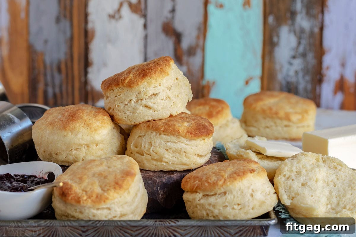Freshly baked Angel Biscuits spread out on a baking sheet, golden and inviting.