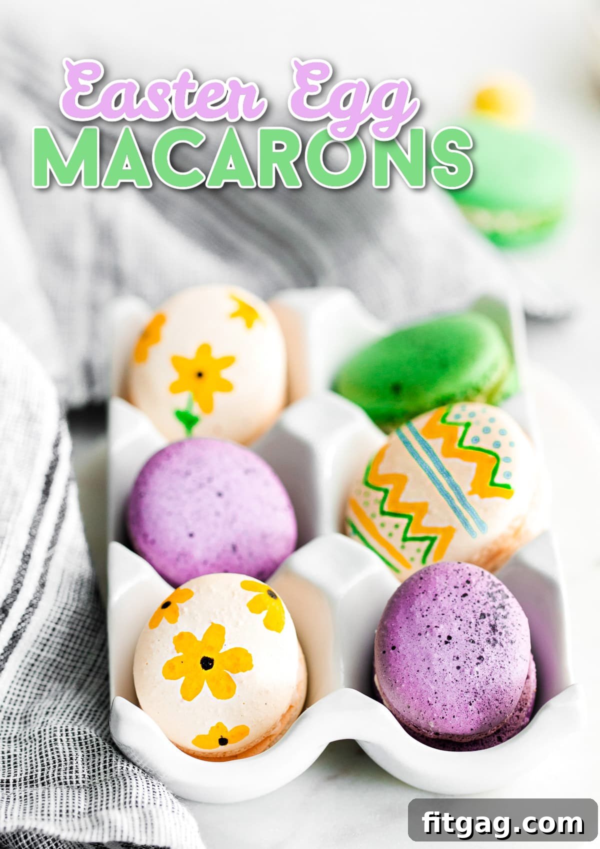 French macarons decorated as Easter eggs sitting in a white egg crate with a festive title overlay.