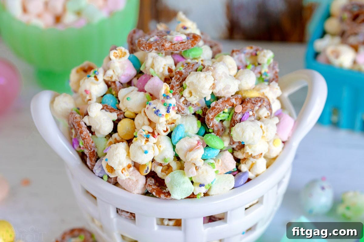 Hoppy Easter Snack Blend 3 A close-up view of the Bunny Bait Easter Snack Mix, showcasing colorful Easter sprinkles, candy, and white chocolate coating.