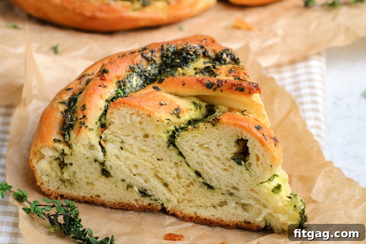 A single, golden-brown piece of garlic herb bread resting on brown parchment paper, highlighting its texture and inviting warmth.