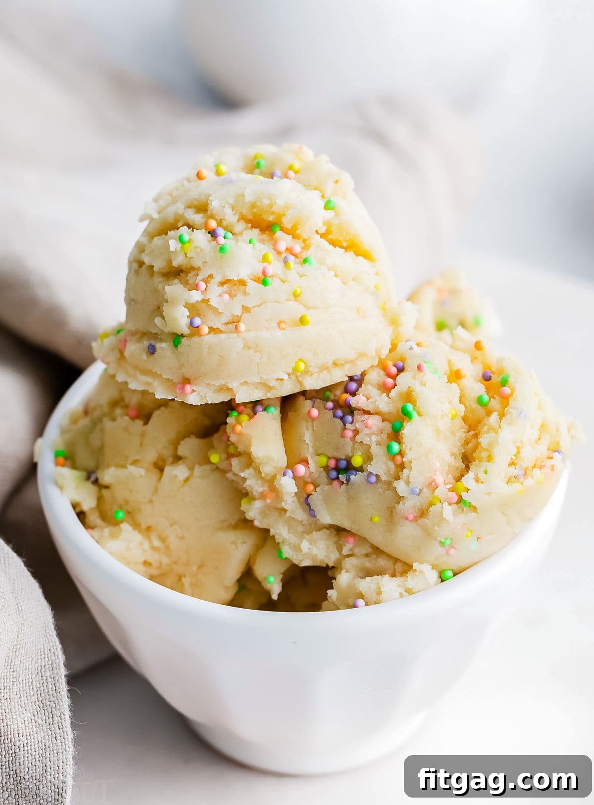 No-Bake Sugar Cookie Bliss 6 edible cookie dough with sprinkles in white bowl.