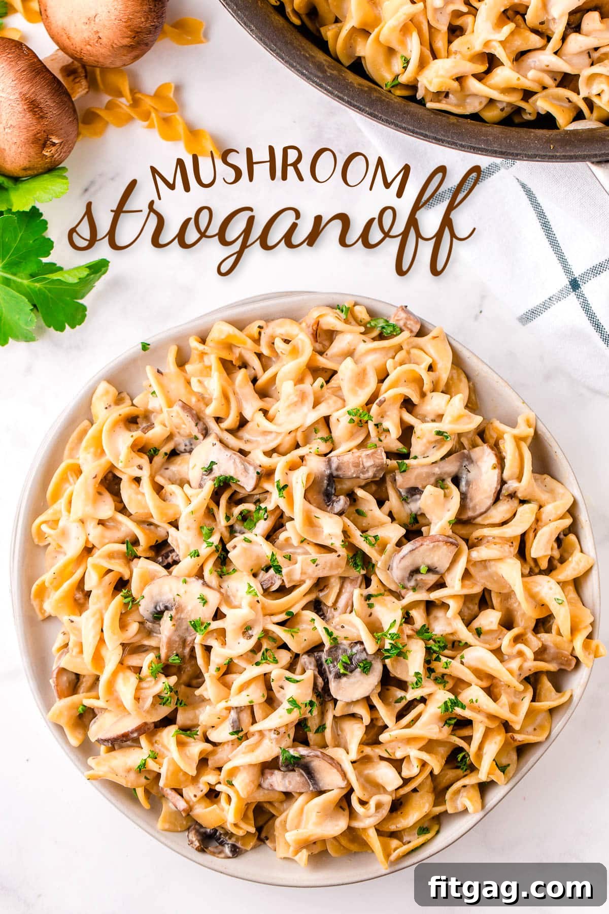 top down view of mushroom stroganoff piled high on round white plate garnished with parsley. text overlay at top of image.