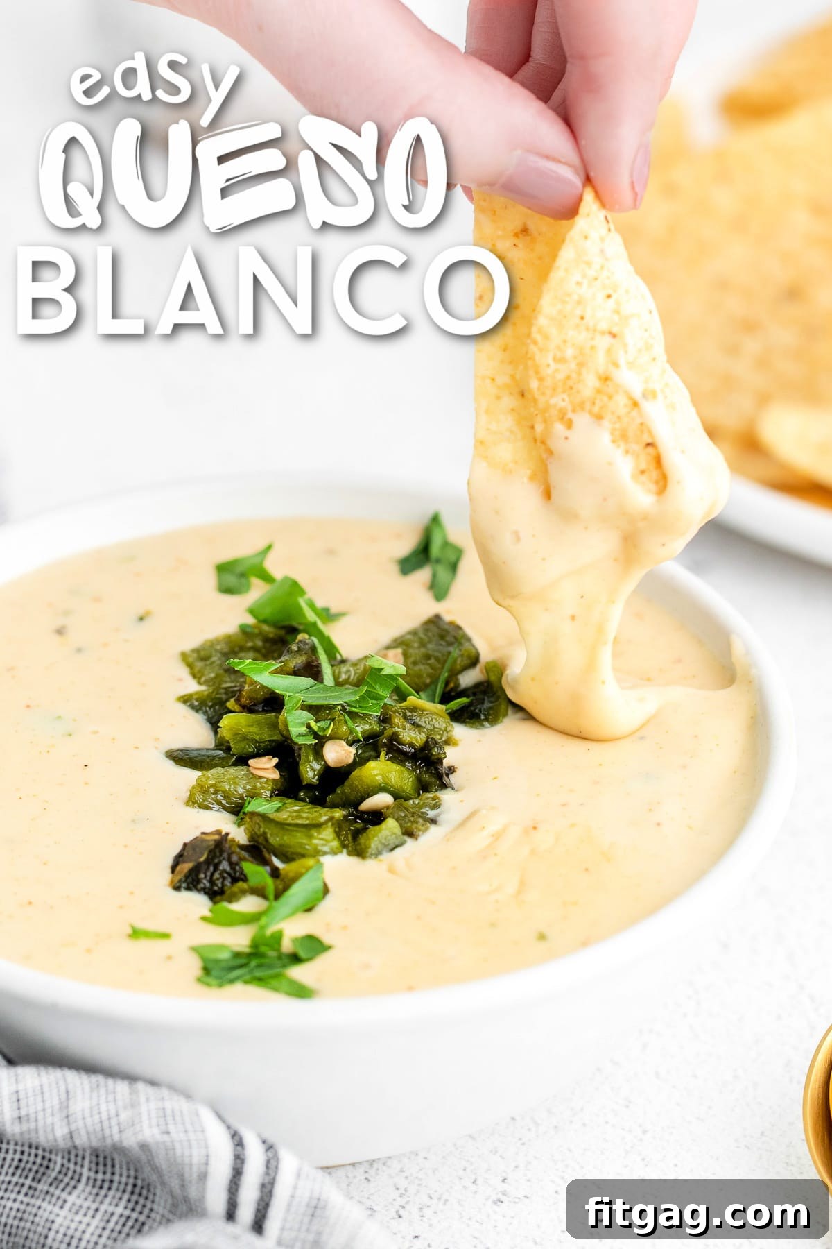 Irresistible Queso Blanco Dip 2 chip being dipped in queso blanco with charred poblanos on top. title overlay at top of image.