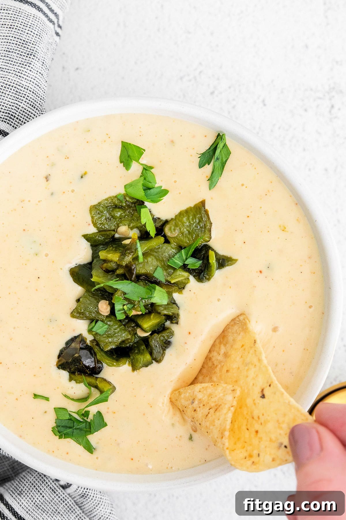 Irresistible Queso Blanco Dip 7 large bowl of queso whip chip being dipped.