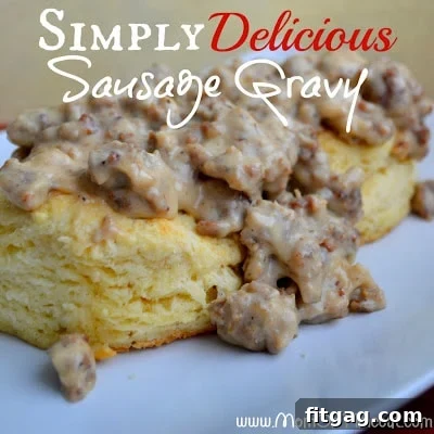 A stack of golden-brown biscuits drowning in rich, creamy homemade sausage gravy.