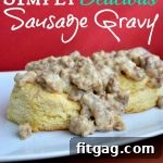 Close-up of freshly made sausage gravy with a spoon, highlighting its creamy texture.