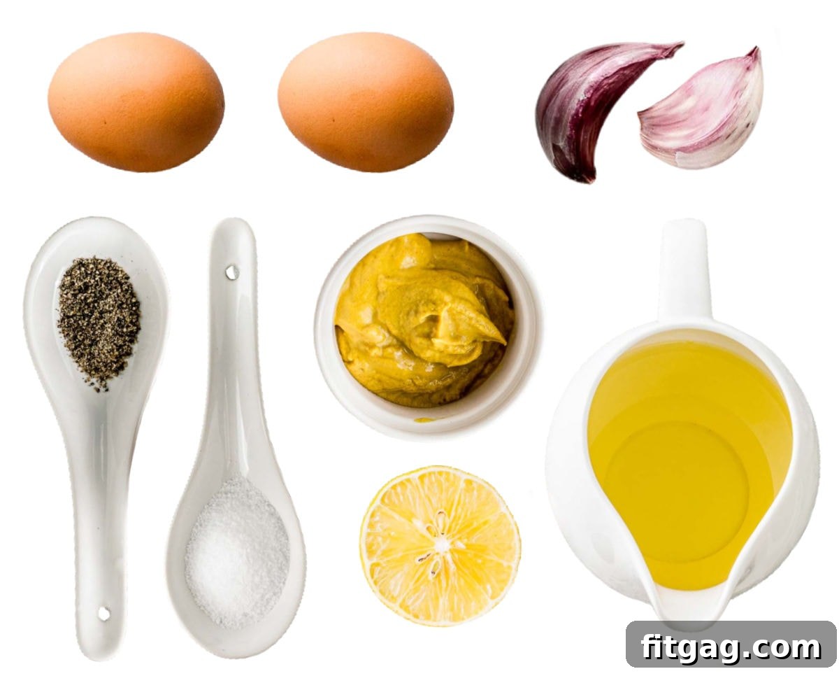 All aioli ingredients precisely measured and laid out in small bowls on a clean white background.
