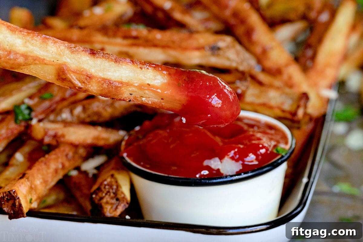 fry being dipped in ketchup.