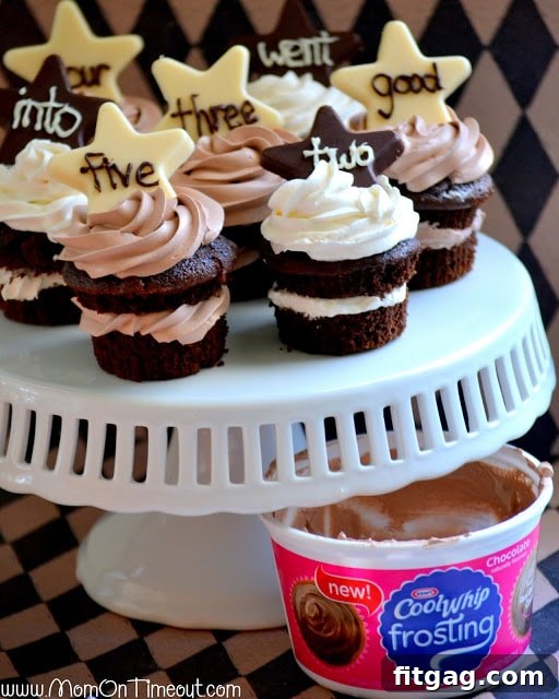 A close-up of a perfectly frosted chocolate cupcake with an 'all-star' chocolate topper.