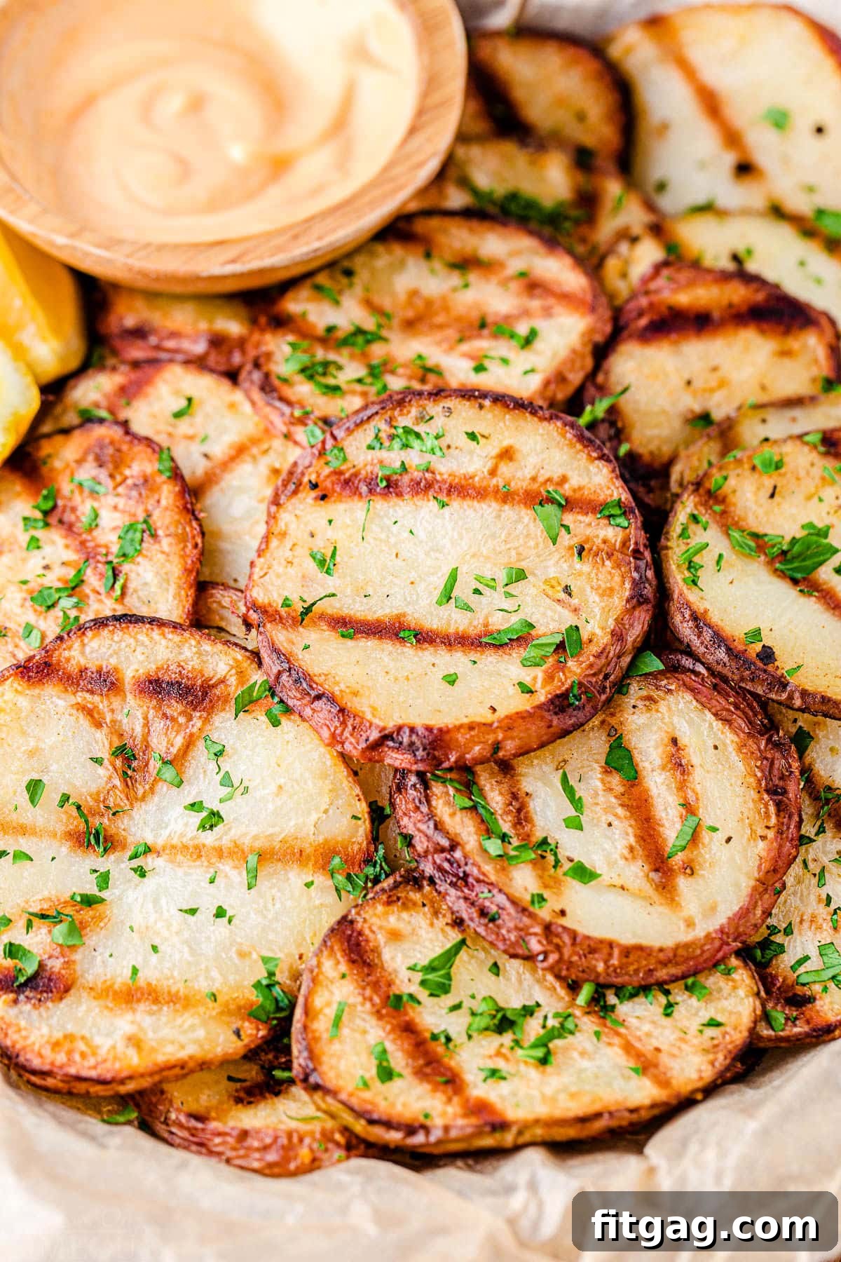 Smoky Garlic Herb Potatoes 5 Close-up shot of grilled potato slices showing distinct char marks and a golden-brown finish, perfectly cut and ready for serving.