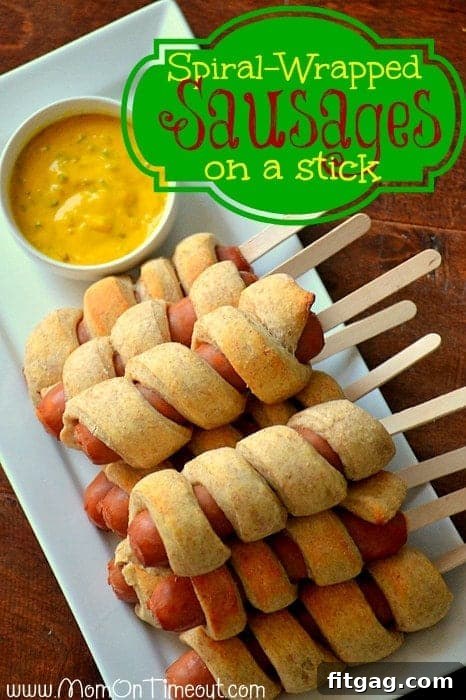 A stunning shot of golden-brown Spiral-Wrapped Sausages on a Stick, ready to be enjoyed, emphasizing their visual appeal as a party food.