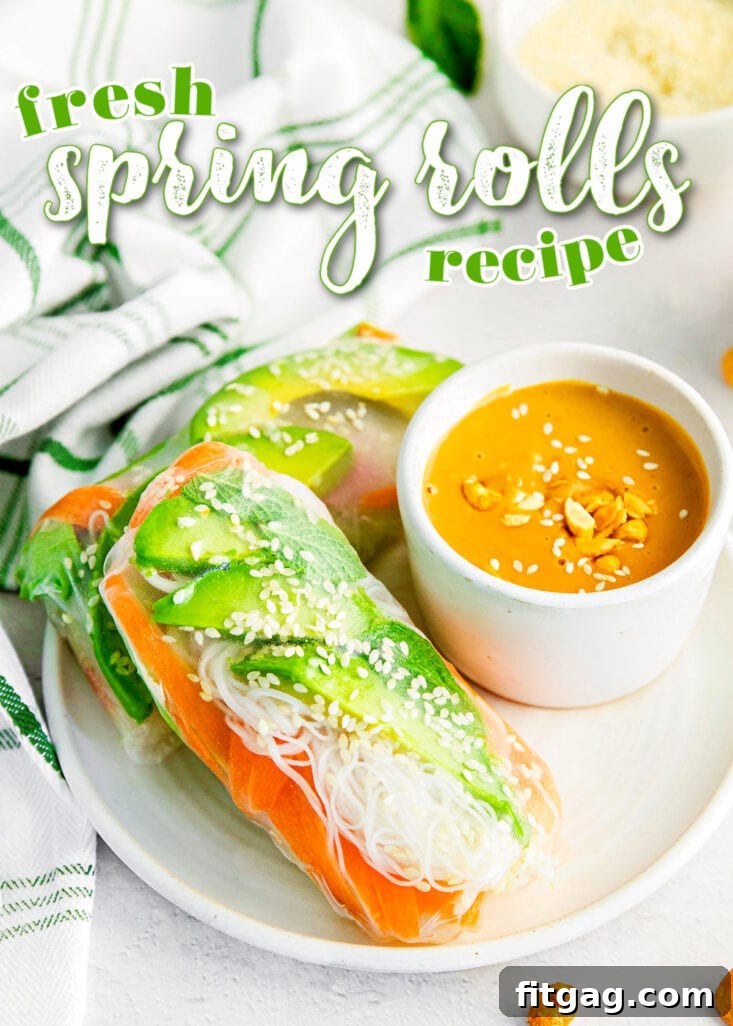 Spring rolls on a white plate with a small bowl of peanut sauce for dipping.