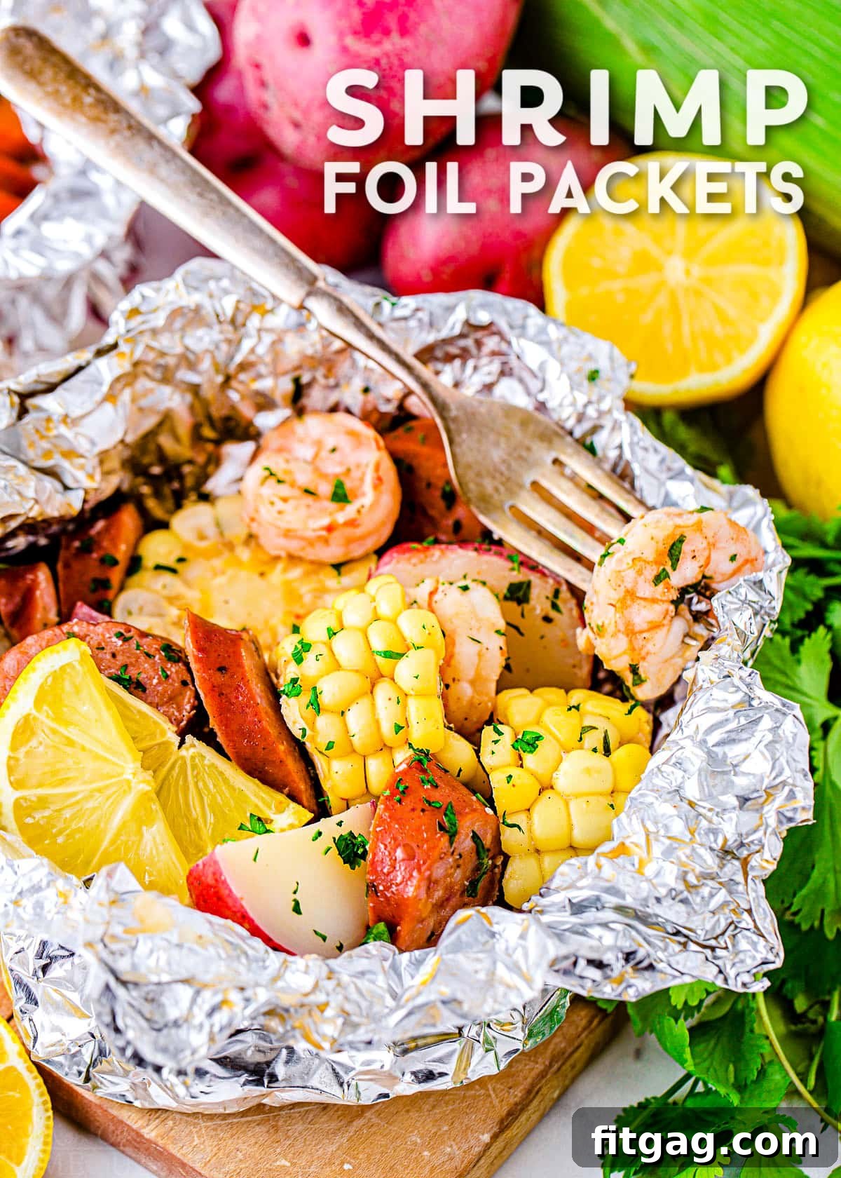 Effortless Shrimp Foil Packs 2 shrimp boil cooked in foil with corn, sausage, shrimp and potatoes. Title overlay at top of image.