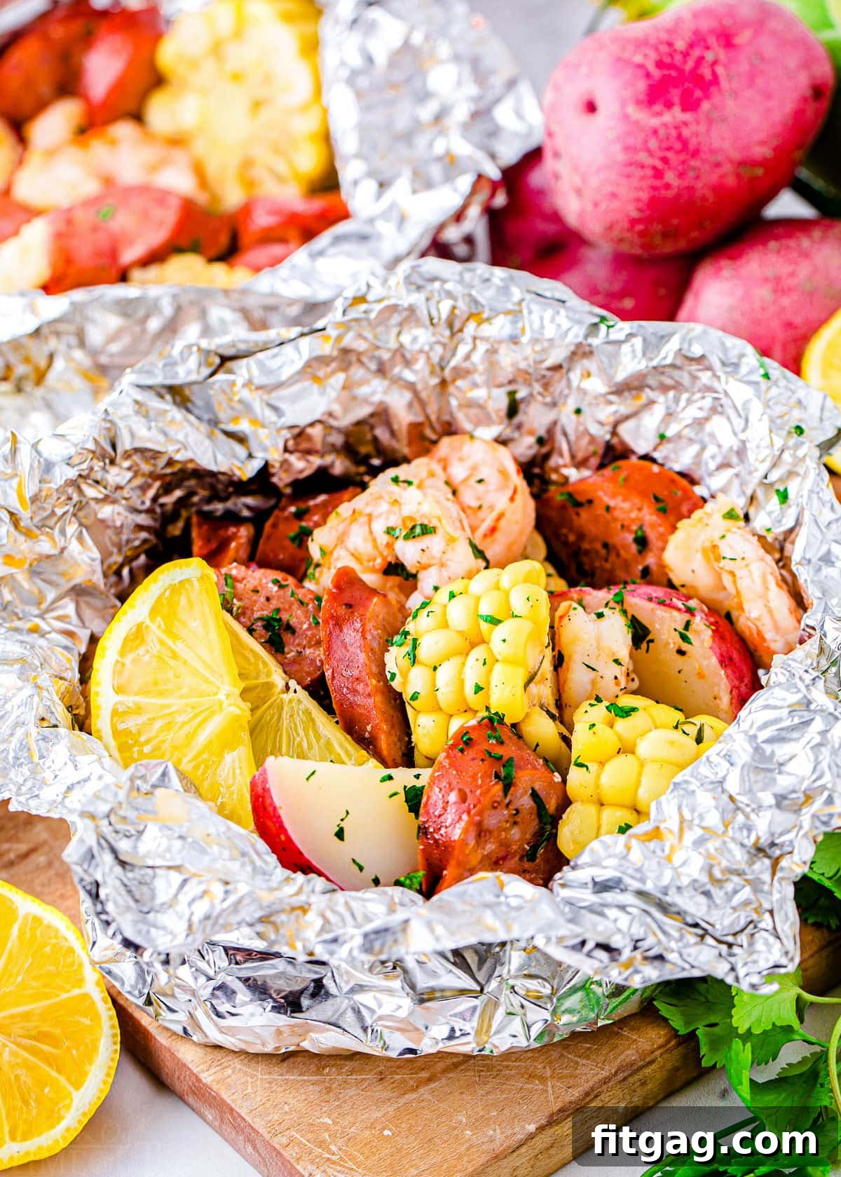 Effortless Shrimp Foil Packs 4 grilled shrimp boil made in foil packets with corn, sausage and shrimp.