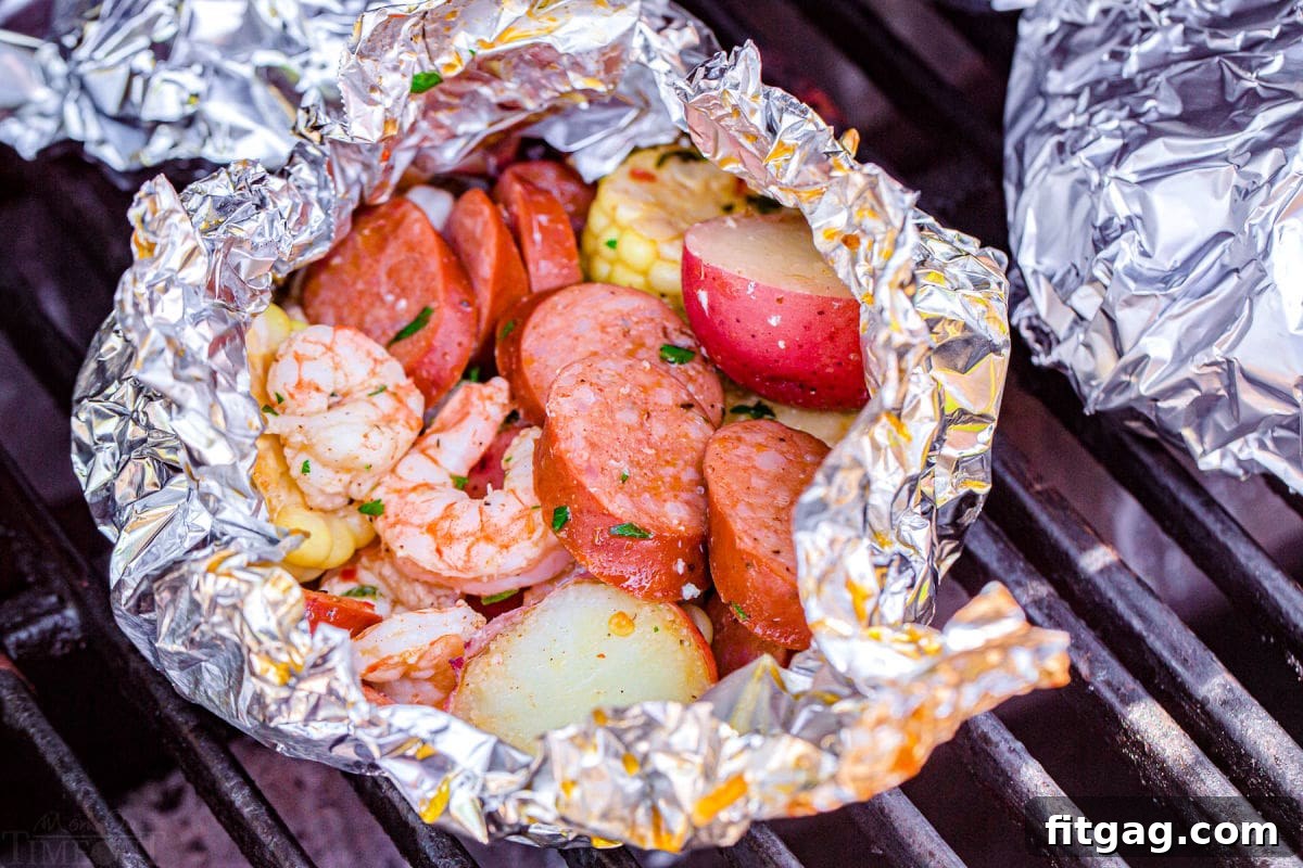 Effortless Shrimp Foil Packs 6 shrimp foil packets being made on the grill.