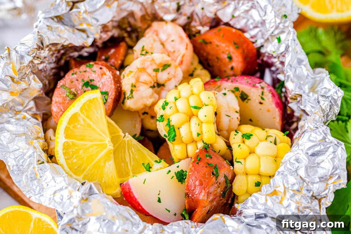 Effortless Shrimp Foil Packs 7 close up look at shrimp foil packets with corn, potatoes, shrimp, sausage and herbs.