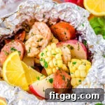 grilled shrimp boil made in foil packets with corn, sausage and shrimp.
