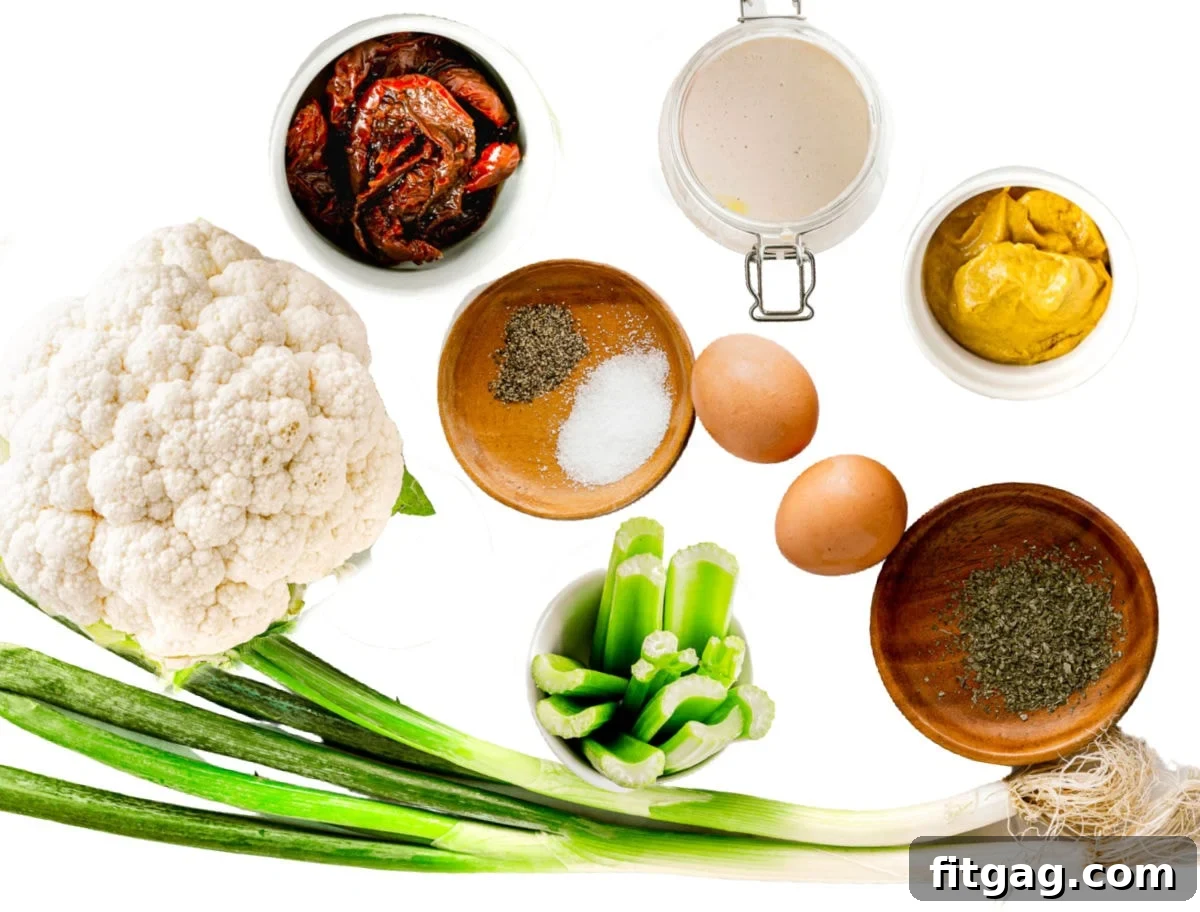 All ingredients for cauliflower salad laid out neatly on a white surface, ready for preparation.