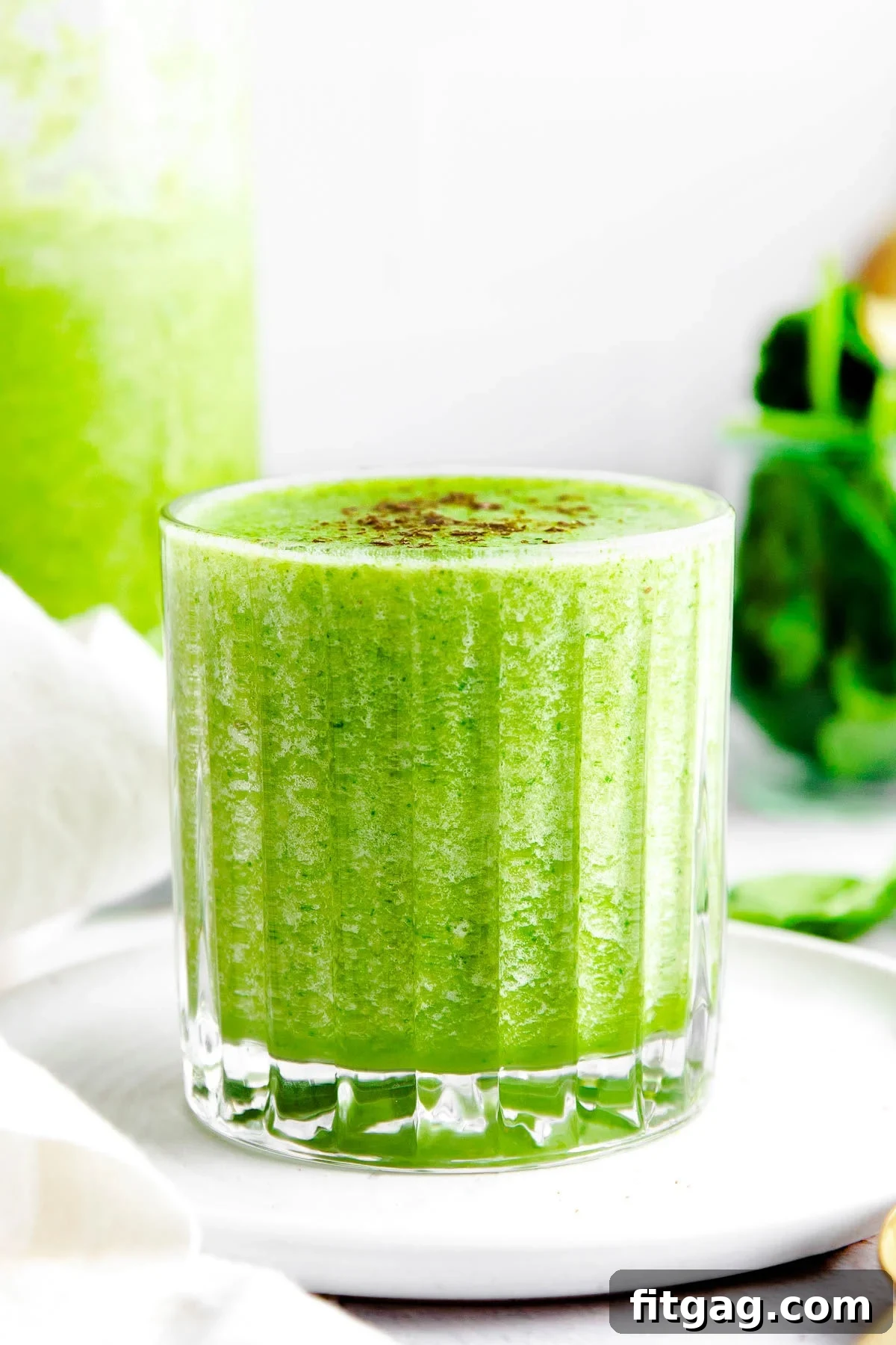 The Perfect Green Smoothie 6 A simple glass filled to the brim with a bright green smoothie, showcasing its inviting color and smooth texture, ready to be enjoyed.