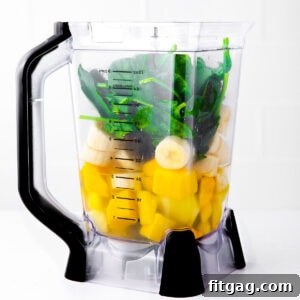 The Perfect Green Smoothie 8 blender with green smoothie ingredients in it ready to blend.