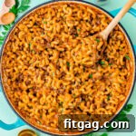 skillet of homemade hamburger helper garnished with chopped fresh parsley.