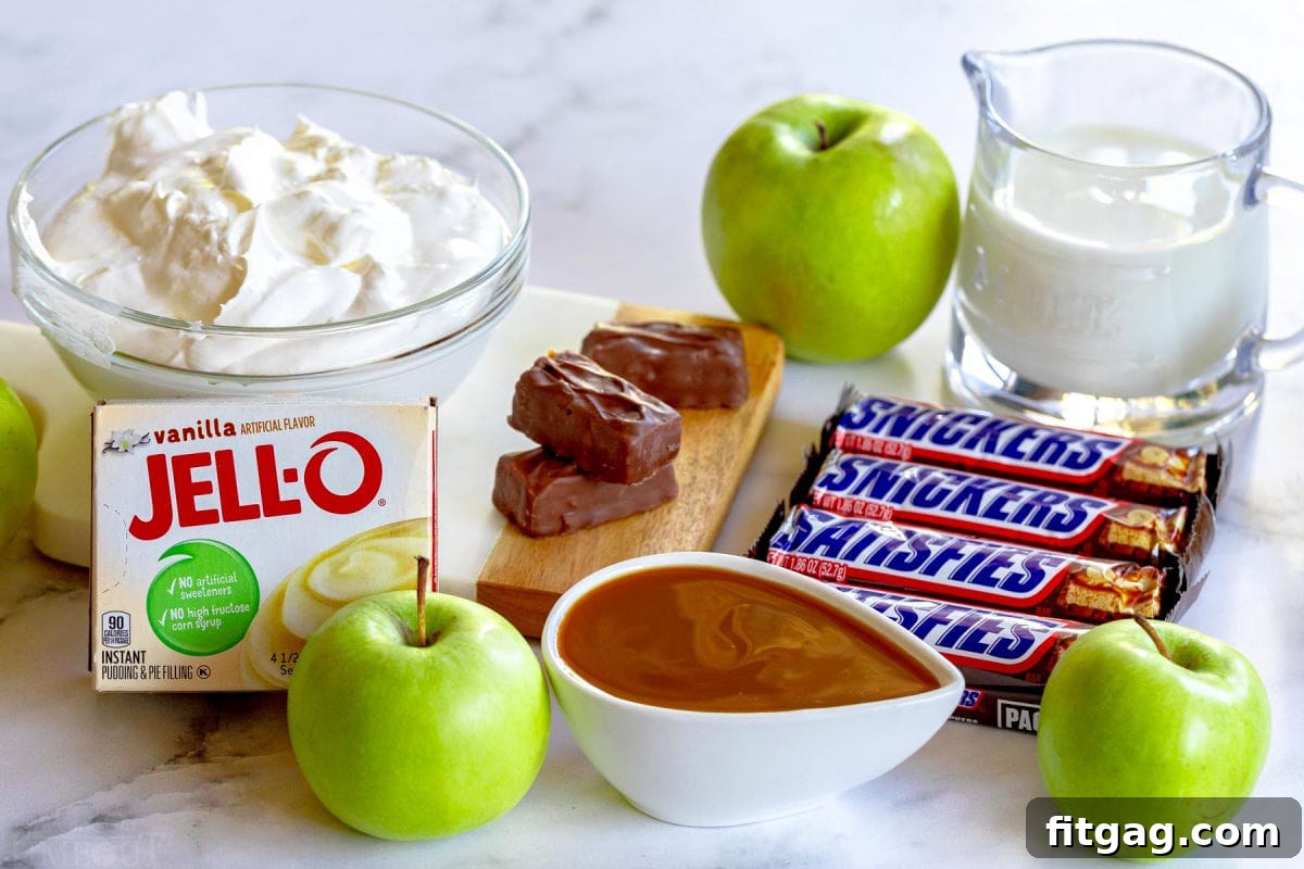 Snickers Caramel Apple Delight 5 snicker salad recipe ingredients laid out ready to use in recipe.