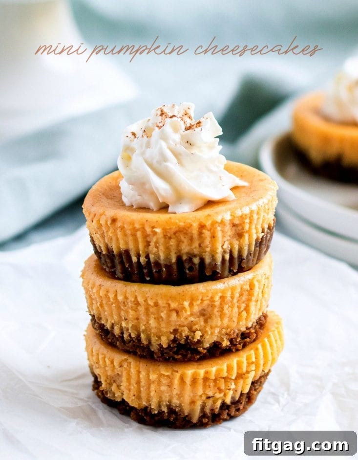 Multiple mini pumpkin cheesecakes stacked on a white plate, ready for serving