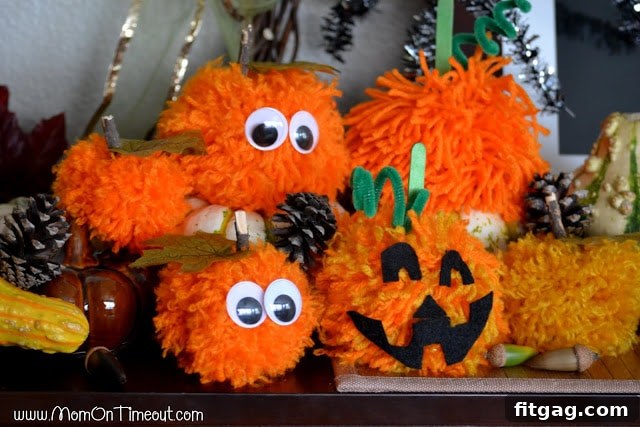 A charming close-up of a decorated pom pom pumpkin, ready for display during the Halloween season.