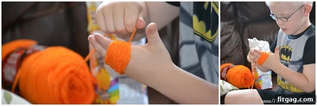 Hands wrapping yarn around fingers to create the base for a pom pom. A crucial step in DIY pom pom making for crafts.