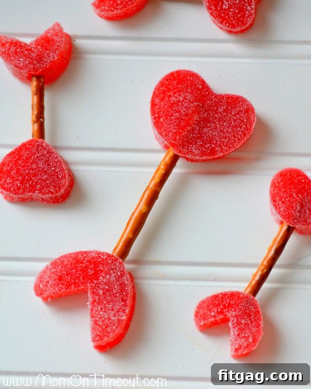 Creative Variations for Cupid's Arrows: Customize Your Valentine's Day Treats An array of finished Cupid's Arrows, showcasing different sizes and styles created with various gumdrops and pretzel stick lengths.