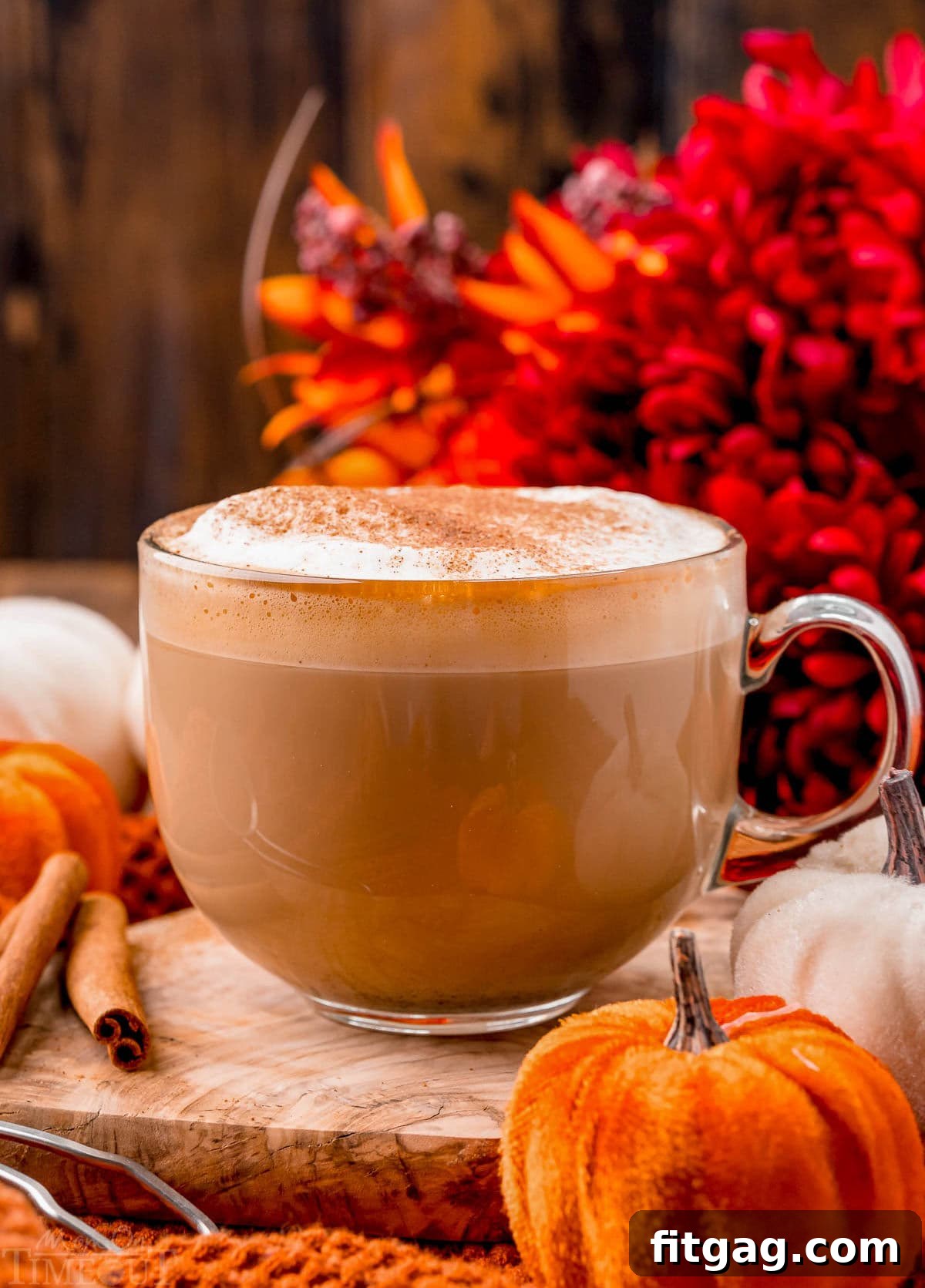 perfect mug of homemade pumpkin spice latte sitting olive board ready to be enjoyed.