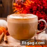perfect mug of homemade pumpkin spice latte sitting olive board ready to be enjoyed.
