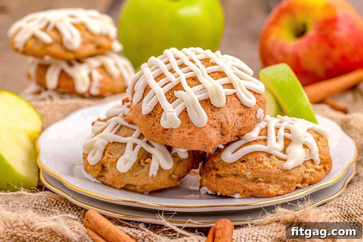 A wide shot of a platter brimming with freshly baked apple cookies, each beautifully adorned with a zig-zag pattern of maple icing, inviting a closer look.