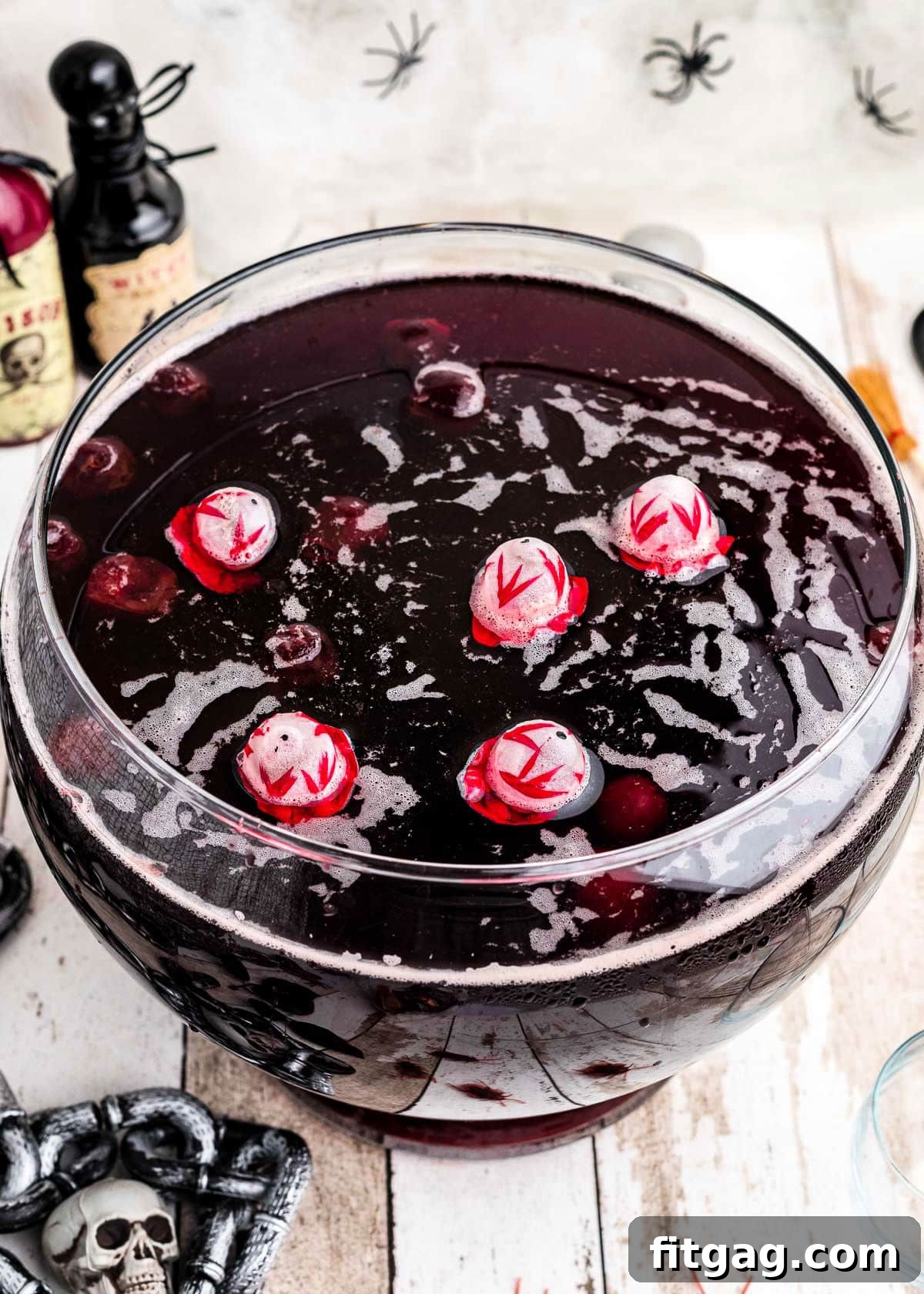 A top-down view of Halloween punch in a glass punch bowl, adorned with skull ice cubes for a spooky touch.