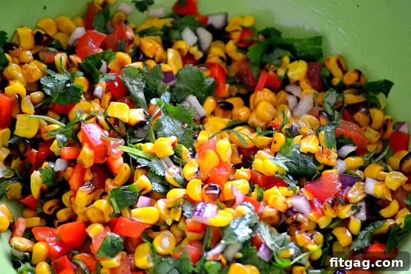 Ingredients for Roasted Corn Salsa including corn, tomatoes, onions, and cilantro