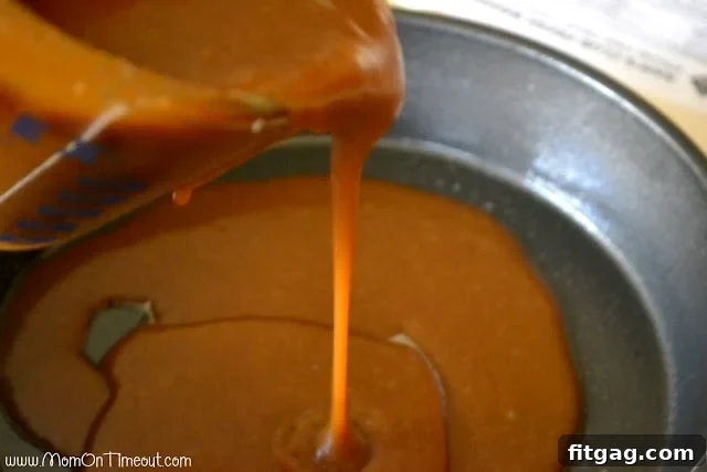 Liquid caramel sauce poured into the bottom of a round baking pan, forming a sticky base for the buns.