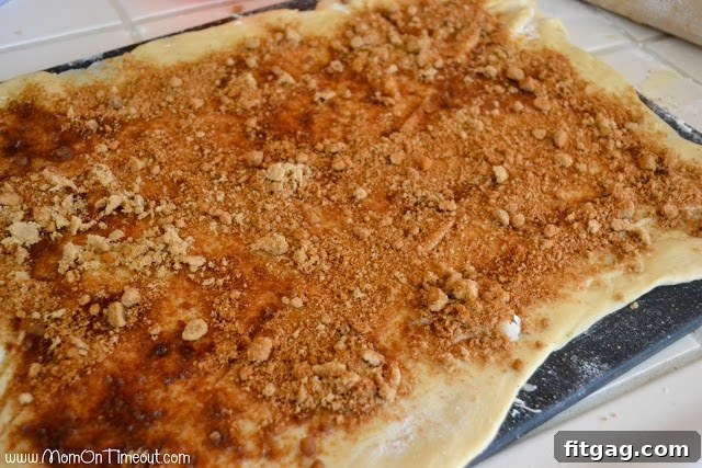 Brown sugar and cinnamon mixture sprinkled generously over buttered dough, creating the sweet filling.