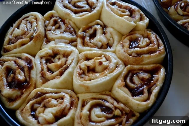 Baked sticky buns in a pan, golden brown and glistening with caramel, fresh from the oven.