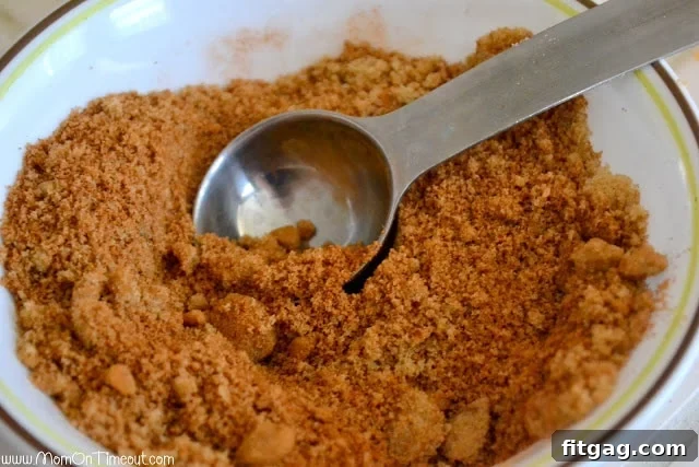 Diced apples, a bowl of cinnamon-brown sugar mixture, and melted butter, all prepped for the sticky bun filling.