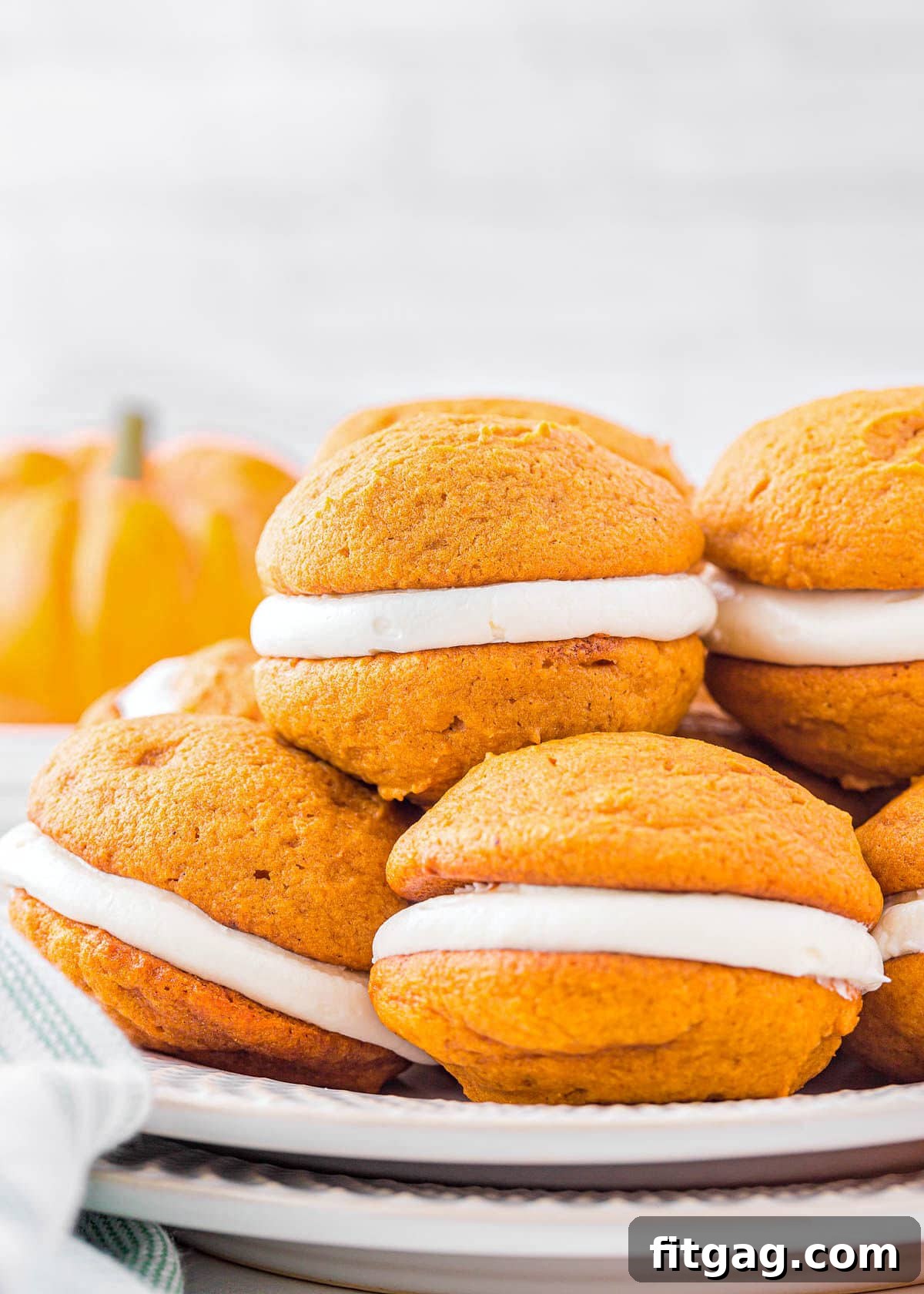 Pillowy Pumpkin Cream Sandwiches 2 plate with six pumpkin whoopie pies stacked on each other.
