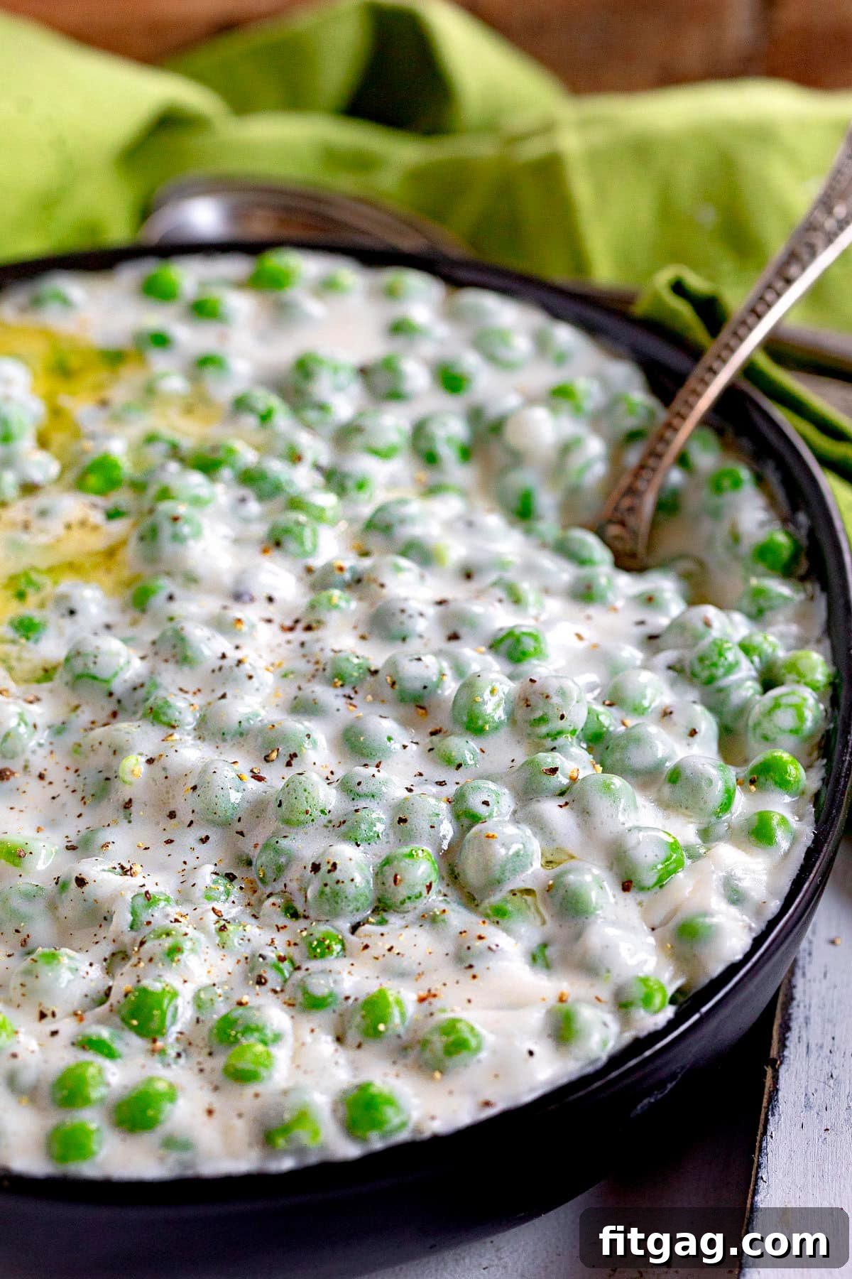 Velvet Peas 5 A large black bowl filled to the brim with creamy, comforting creamed peas.