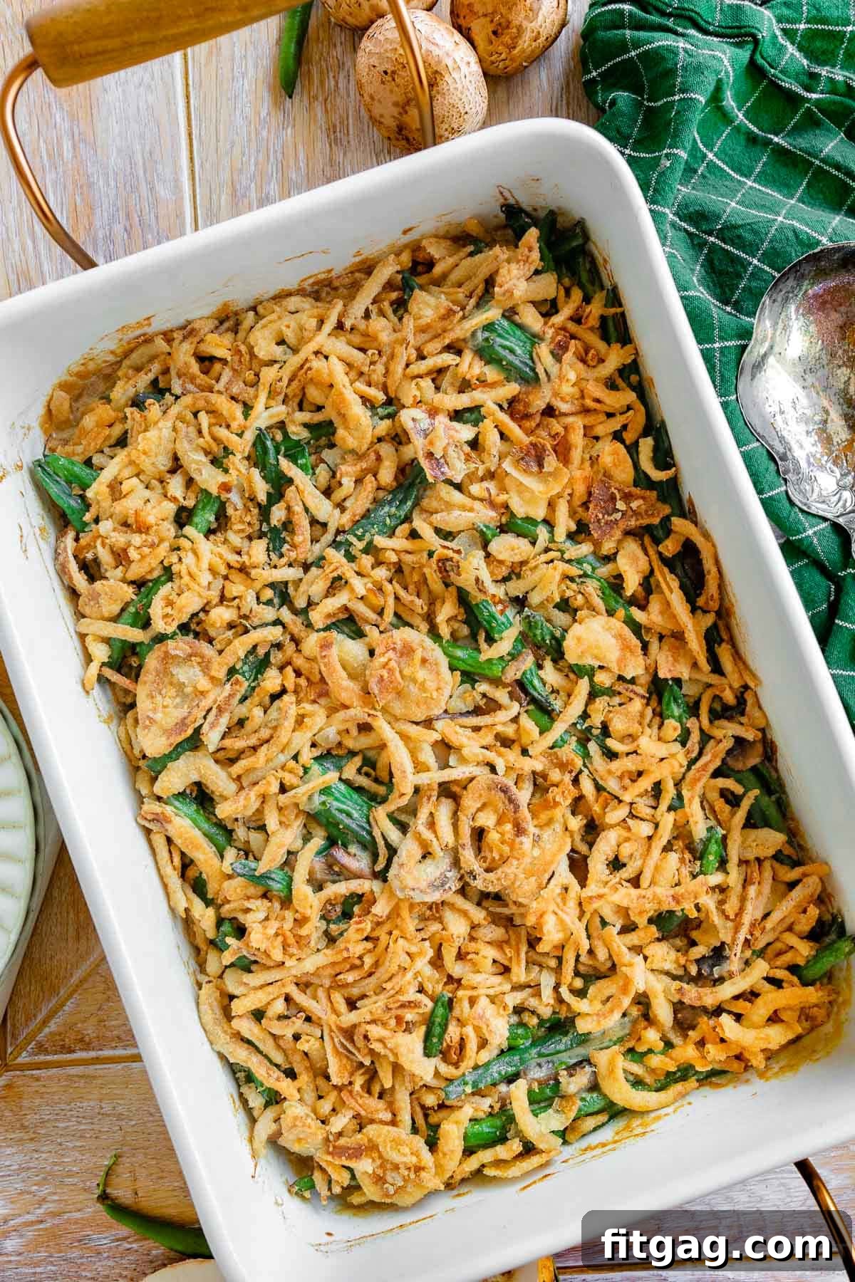 Crispy Onion Green Bean Delight 3 A beautiful top-down view of a freshly baked green bean casserole in a white baking dish, ready to be served. The crispy fried onion topping gleams golden.