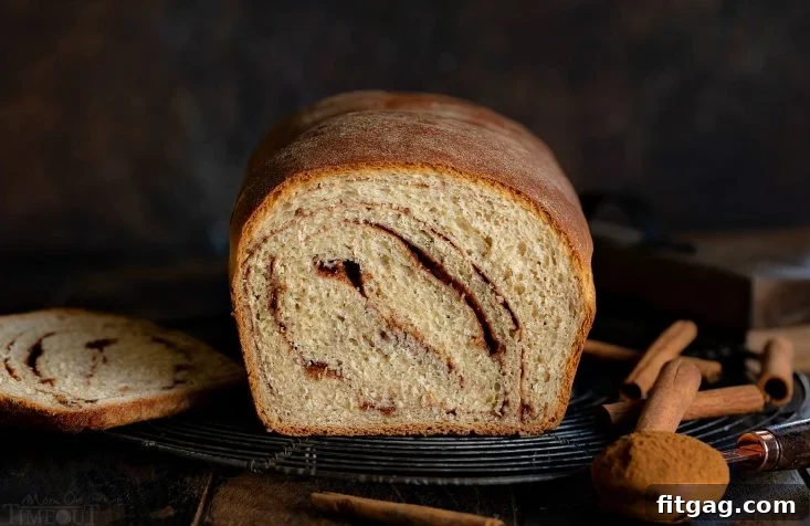 Homemade Cinnamon Bread is a thing of beauty and you'll never believe how easy it is to make! Homemade bread is always a special treat but when you add in swirls of cinnamon sugar? PERFECTION. Use the leftovers for French toast this weekend! Perfect for breakfast and brunch. // Mom On Timeout #cinnamonbread #bread #baking #cinnamon #breakfast #brunch #breadmaking cinnamon bread recipe wide shot