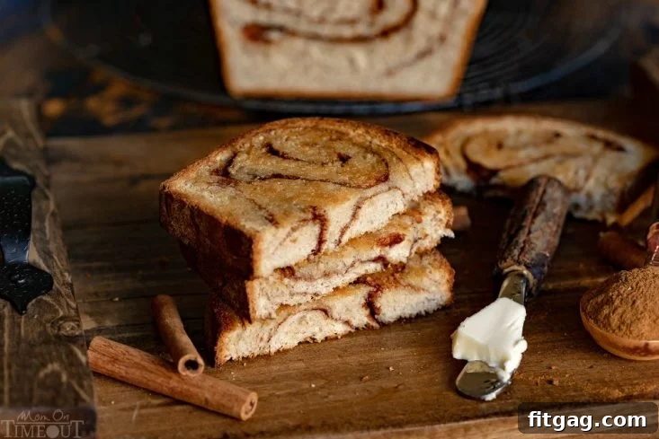 Homemade Cinnamon Bread is a thing of beauty and you'll never believe how easy it's to make! Homemade bread is always a special treat but when you add in swirls of cinnamon sugar? PERFECTION. Use the leftovers for French toast this weekend! Perfect for breakfast and brunch. // Mom On Timeout #cinnamonbread #bread #baking #cinnamon #breakfast #brunch #breadmaking cinnamon bread toasted with butter on board