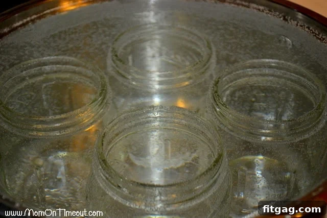 Sterilized canning jars and equipment, ready for filling with fresh homemade pasta sauce for preservation.