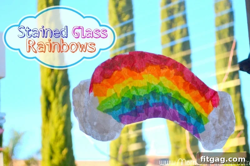 Sparkling Rainbow Suncatchers 8 Finished Stained Glass Rainbow craft hanging on a window, with sunlight shining through, highlighting the vibrant colors and glass-like effect.