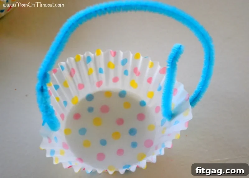 A charming collection of miniature Easter baskets crafted from patterned cupcake liners, each featuring a colorful pipe cleaner handle, awaiting their sweet contents.