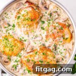 top down look a the chicken fricassee in the skillet with the white wine mushroom sauce.