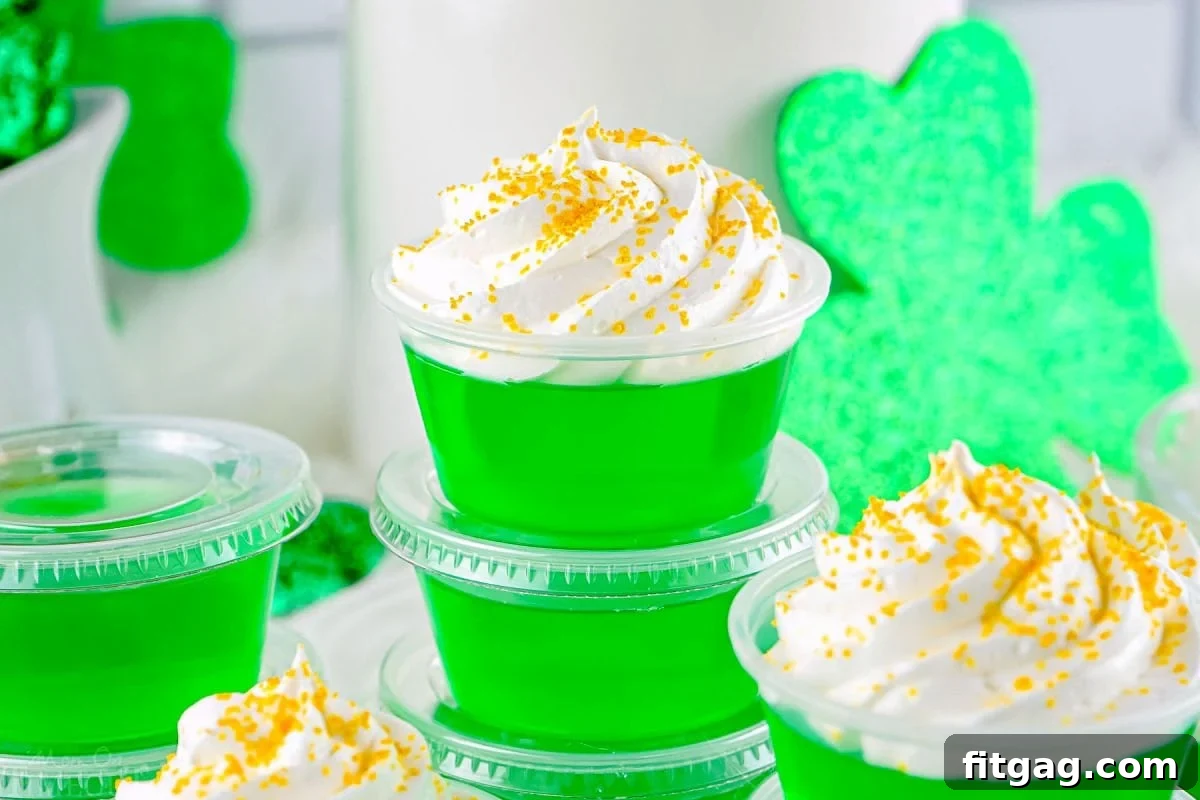 A wide shot showcasing numerous vibrant green jello shots, perfectly themed for St. Patrick's Day, arranged attractively for a party.